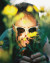A man wearing Oakley sunglasses looking through a field.