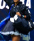 Naomi Osaka walks onto court at the 2024 US Open wearing a custom Nike outfit by Yoon Ahn, featuring Harajuku-inspired bows and ruffles in a bold nod to Japanese fashion.